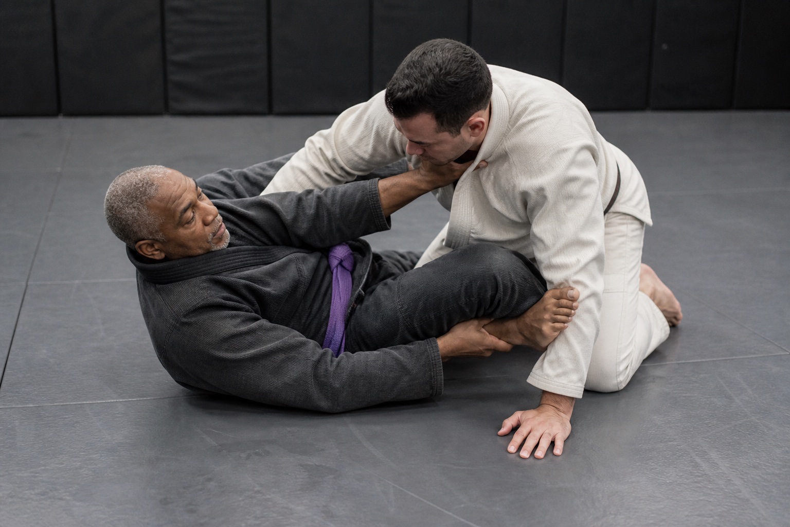 Older practitioner uses frames and a knee shield to recover half guard.